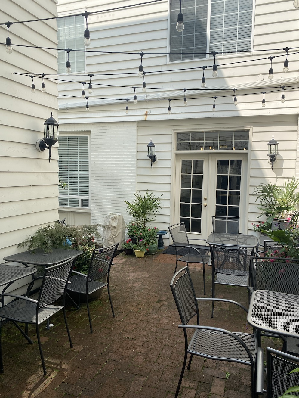 Outdoor patio with string lights and bistro tables